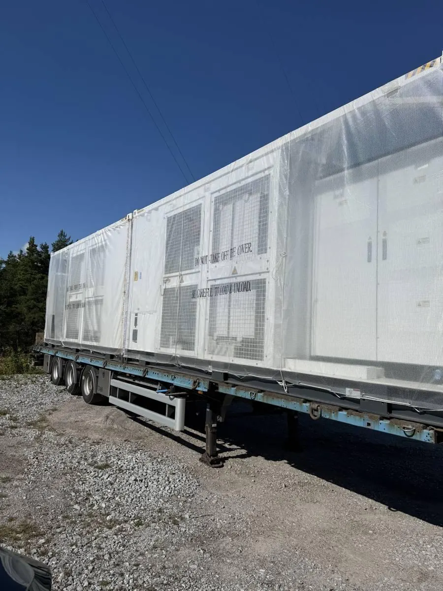 Containere ankommer site på trailer